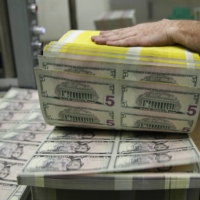 Sheets of U.S. five-dollar bills are printed at the Bureau of Engraving and Printing in Washington in March 2015.  | REUTERS