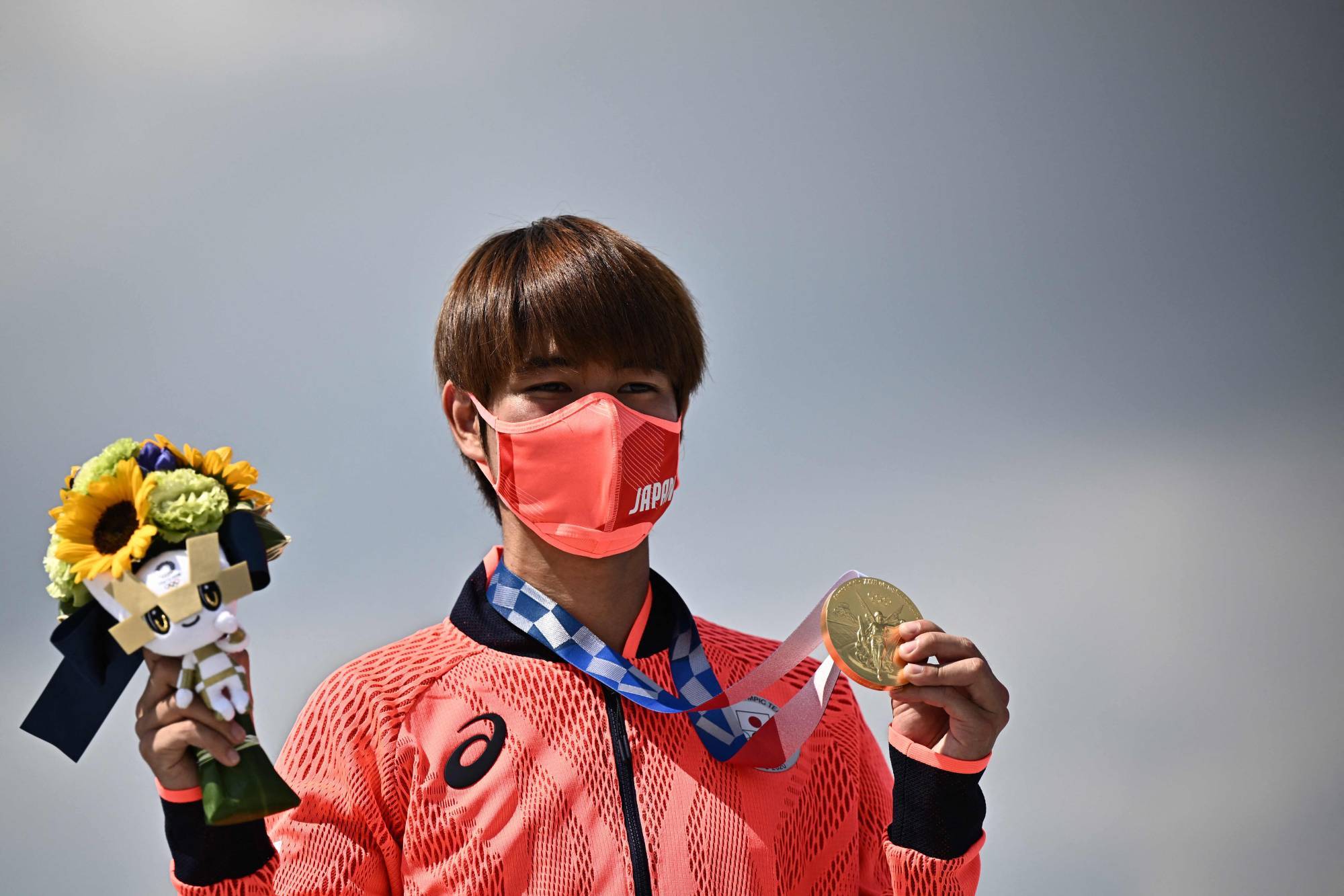 Gold medal-winning skateboarder Yuto Horigome poses on the podium at Ariake Sports Park in Tokyo in July. The kanji of the year referenced the number of gold medals won by Japan's athletes at the 2020 Tokyo Olympics and Paralympics. | AFP-JIJI