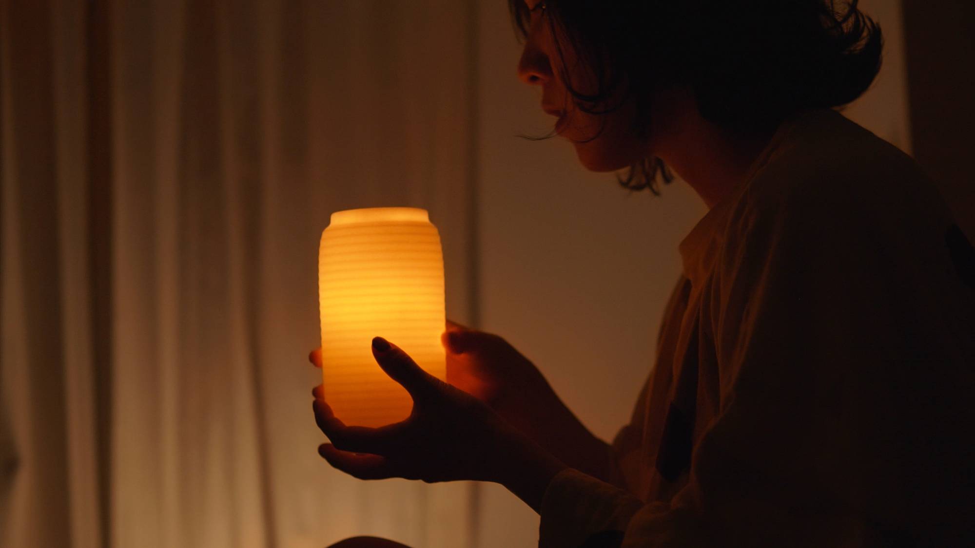 The flame of the Chouchin Candle, designed by James Kaoru Bury, only melts wax at its center, creating a shell inside which the candlelight glows.  | © JAMES KAORU BURY