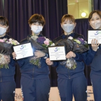 The Japanese women\'s foil team poses for photos following a  | KYODO