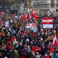 Demonstrators march to protest against COVID-19 restrictions and the vaccine mandate in Vienna on Dec.11. | REUTERS 