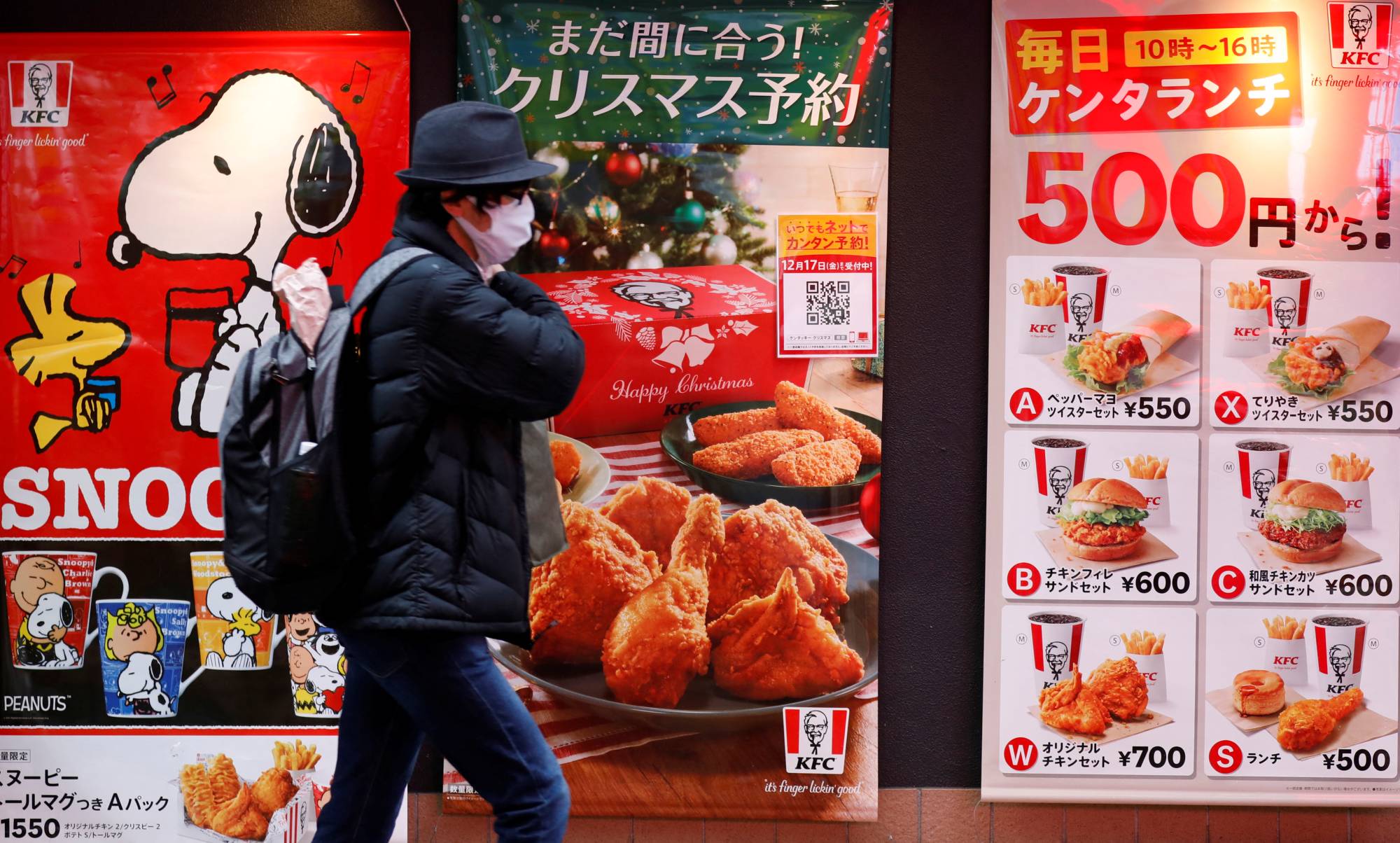 A walks past a KFC restaurant in Tokyo on Tuesday. | REUTERS