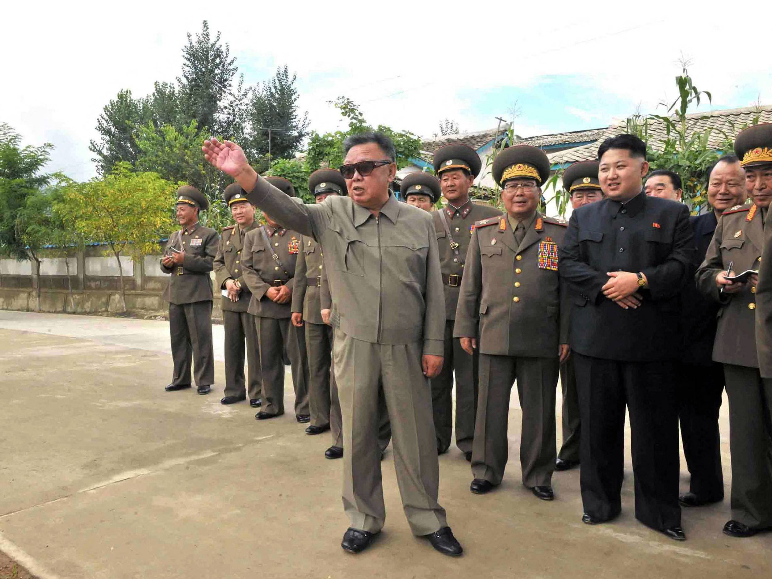 North Korean leader Kim Jong Il is accompanied by his son Kim Jong Un and other officials at a newly built wading pool in Ryongrim county, Jagang province, in this undated picture released on Sept. 2, 2011. | KCNA / KNS / VIA AFP-JIJI