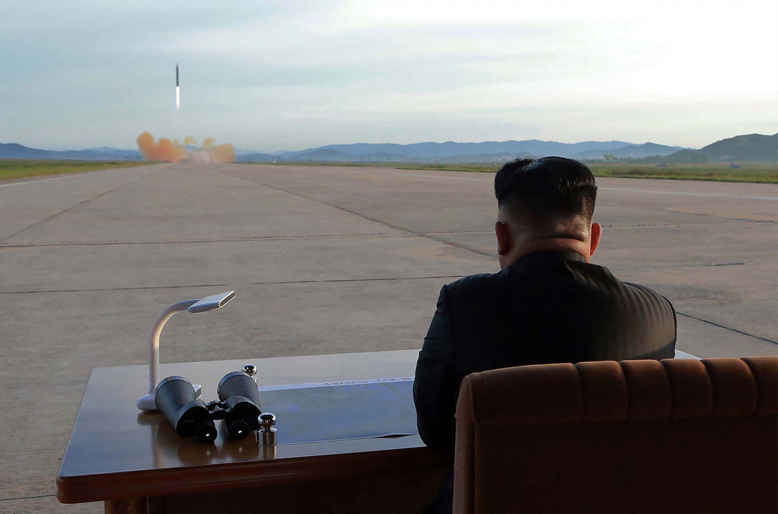 North Korean leader Kim Jong Un watches the launch of a Hwasong-12 ballistic missile at an undisclosed location in this undated photo released on Sept. 16, 2017. | KCNA / KNS / VIA AFP-JIJI