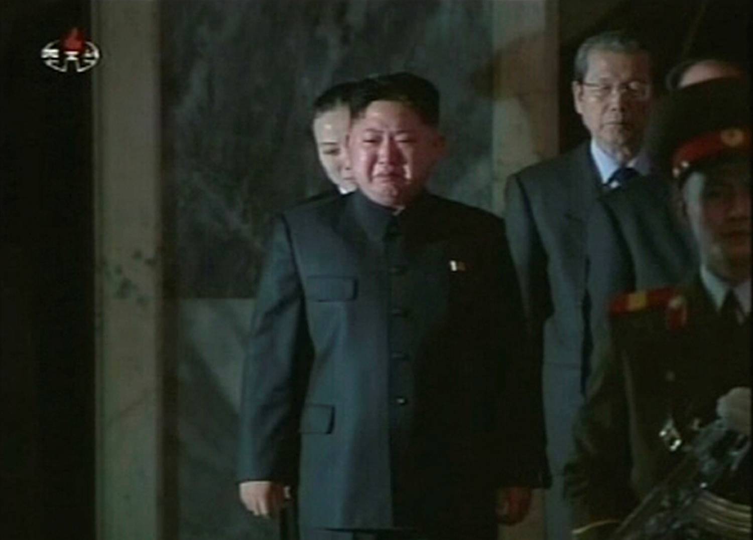 North Korea's Kim Jong Un cries as his father, Kim Jong Il, lies in state during the run-up to his funeral in Pyongyang in this image taken from video broadcast on Dec. 27, 2011. | KCNA / via REUTERS