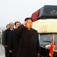 Kim Jong Un salutes beside a convoy carrying the body of his father, late North Korean leader Kim Jong Il, at the Kumsusan Memorial Palace in Pyongyang on Dec. 28, 2011. | KCNA / VIA AFP-JIJI