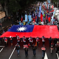 Supporters of Taiwan\'s main opposition party, Kuomintang, join a labor protest in Taipei on Sunday focusing on its opposition to imports of U.S. pork containing ractopamine.  | REUTERS