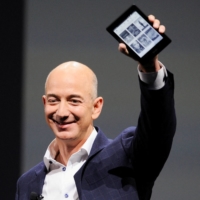 Amazon CEO Jeff Bezos holds up a Kindle Paperwhite during an event in Santa Monica, California, in September 2012. | REUTERS