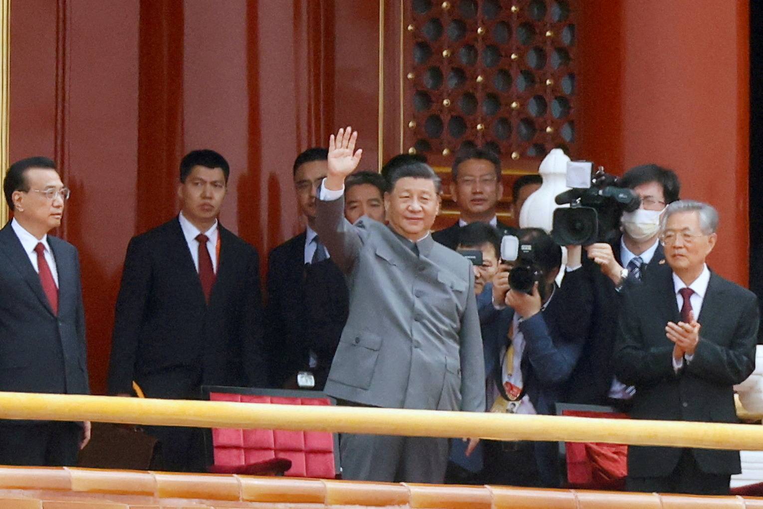 Chinese leader Xi Jinping waves next to Premier Li Keqiang (far left) and former President Hu Jintao (far right) at the end of the event marking the 100th founding anniversary of the Communist Party of China in Beijing's Tiananmen Square on July 1. | REUTERS