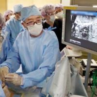 Doctors conduct an operation to treat an unborn baby for severe aortic stenosis at the National Center for Child Health and Development in Tokyo in July. | THE NATIONAL CENTER FOR CHILD HEALTH AND DEVELOPMENT / VIA KYODO