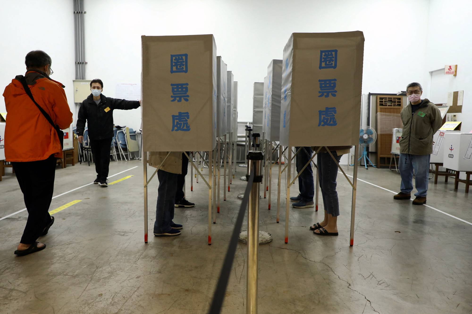 People cast their votes at a Taipei polling station during a four-question referendum in Taiwan. | REUTERS