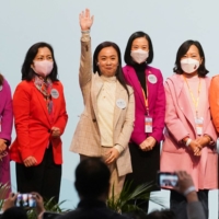 Candidates celebrate after winning in the Legislative Council election in Hong Kong on Dec. 20, 2021.  | REUTERS