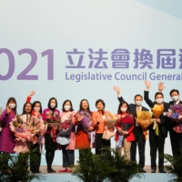 Candidates celebrate after winning in the Legislative Council election in Hong Kong on Dec. 20, 2021.  | REUTERS