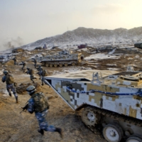 Soldiers of the People\'s Liberation Army Marine Corps train at a military training base in Bayingol, China\'s Xinjiang Uighur Autonomous Region, in January 2016. | REUTERS