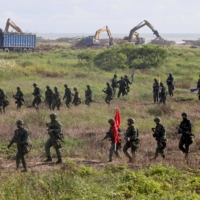Soldiers walk back to base after an anti-invasion formation practice on the beach during the annual Han Kuang military drill in Tainan, Taiwan, in September. | REUTERS