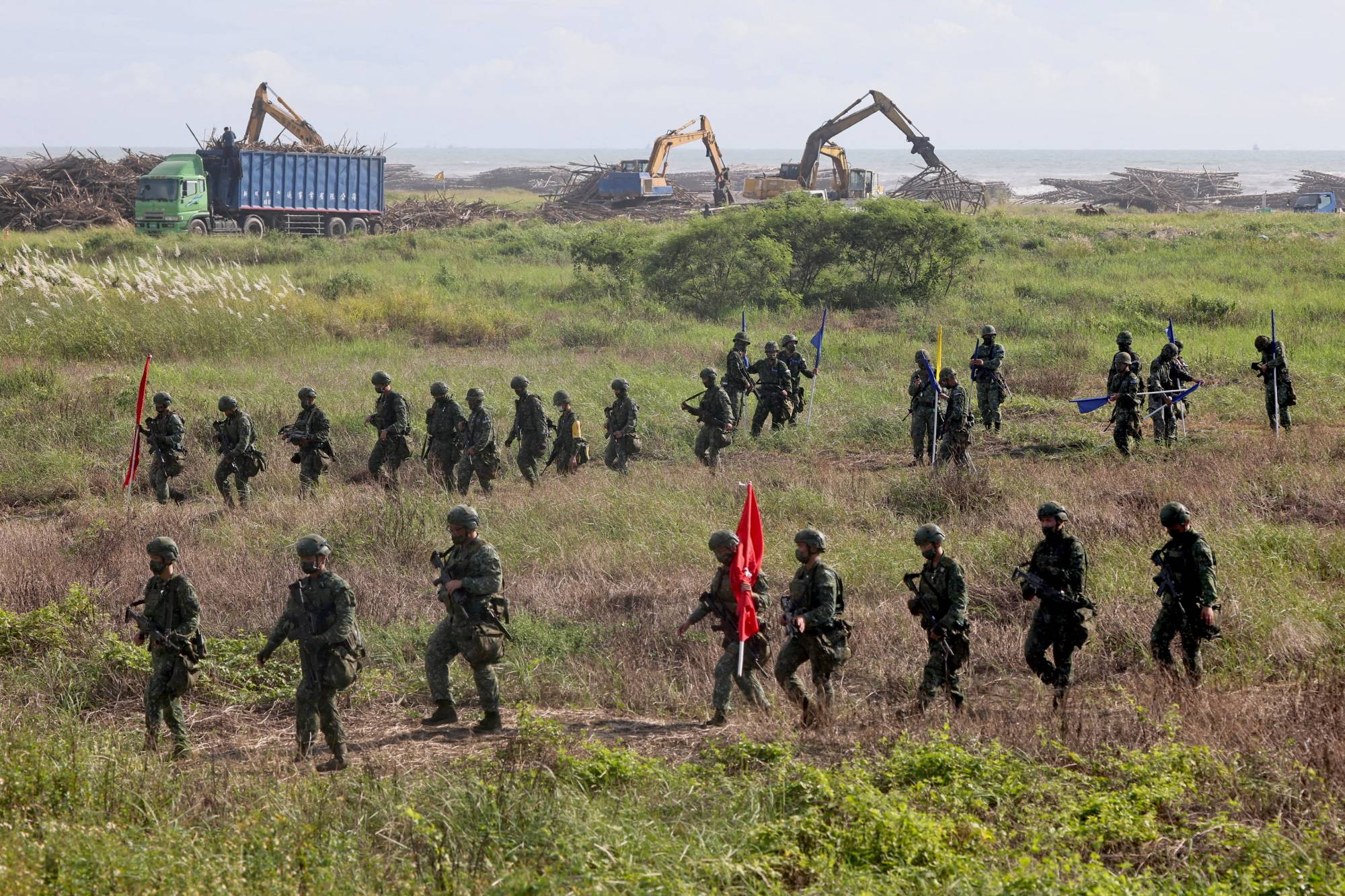 Soldiers walk back to base after an anti-invasion formation practice on the beach during the annual Han Kuang military drill in Tainan, Taiwan, in September. | REUTERS