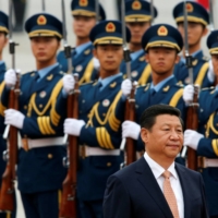 Chinese President Xi Jinping inspects an honor guard at a welcoming ceremony for Venezuelan President Nicolas Maduro outside the Great Hall of the People in Beijing in September 2013. | REUTERS