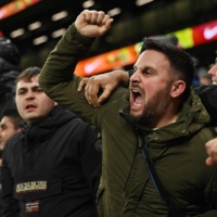 Liverpool fans celebrate a goal during an English Premier League match against Tottenham Hotspur, at Tottenham Hotspur Stadium in London on Sunday. | AFP-JIJI