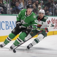 Dallas Stars defenseman Ryan Suter (20) and Minnesota Wild defenseman Matt Dumba (24) vie for the puck at the American Airlines Center on Monday. | JEROME MIRON / USA TODAY / VIA REUTERS