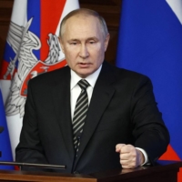 Russian President Vladimir Putin delivers a speech during an expanded meeting of the Defense Ministry Board in Moscow on Tuesday.  | SPUTNIK / POOL / VIA REUTERS