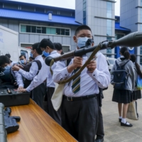 Schoolchildren during National Security Education Day at the Hong Kong Police College on April 15 | BLOOMBERG 