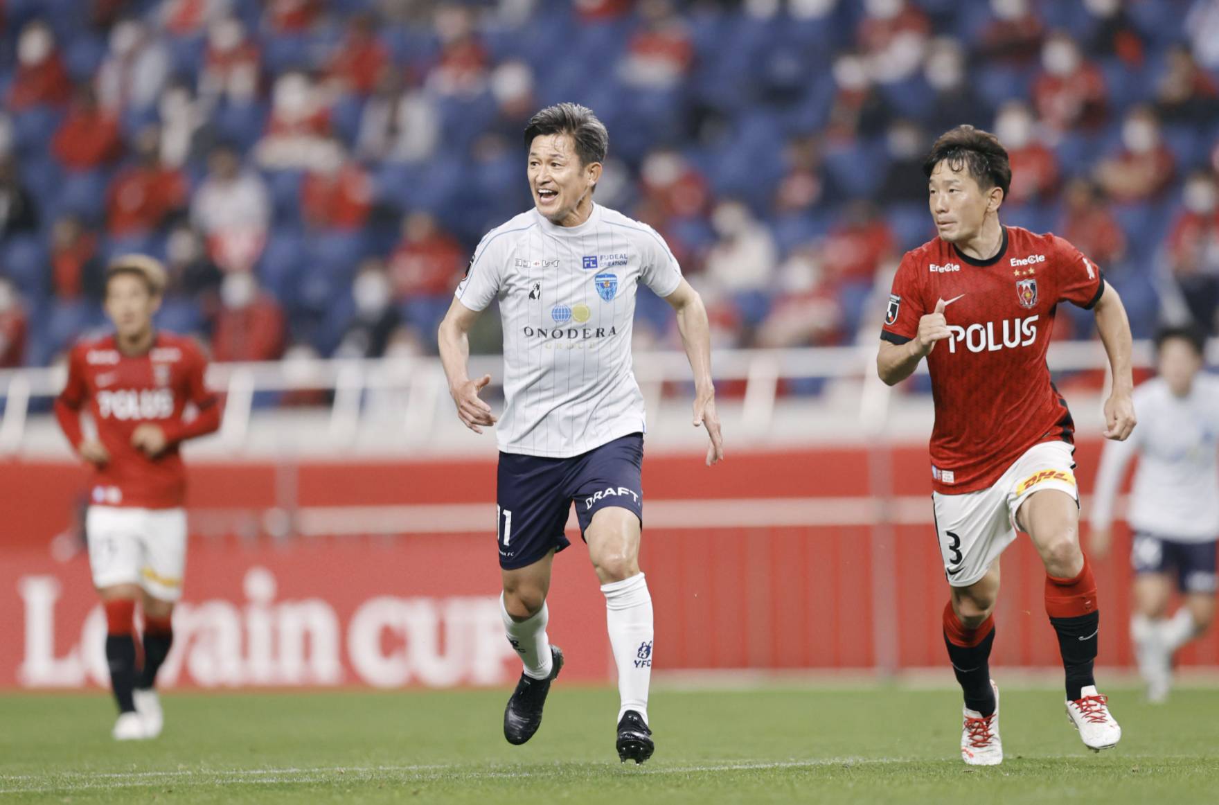 Yokohama FC's Kazuyoshi Miura (center) plays during a Levain Cup soccer match against Urawa Reds on May 19, 2021, in Saitama — extending his record as the oldest player to appear in the cup competition to 54 years, 2 months and 23 days. | KYODO