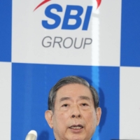 SBI Holdings Inc. Chief Executive Officer Yoshitaka Kitao speaks at a news conference in Tokyo on Wednesday. | KYODO