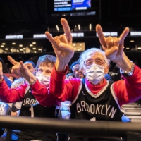 Brooklyn Nets fans attending a game on Oct. 14. Although the omicron variant has begun to spread in the U.S. in recent weeks, NBA Commissioner Adam Silver feels the league has a responsibility to keep playing | BRITTAINY NEWMAN / THE NEW YORK TIMES