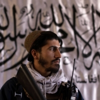 Taliban member Muhammad Ajmal, 22, a sniper who says he has been with the Taliban for ten years, holds an M4 rifle at his office in Kabul on Oct. 19. \"For those who call themselves the superpower: we showed them they can also bow down. All our success is thanks to our prayers,\" Ajmal said. | REUTERS