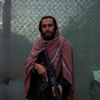 Taliban member Shafiullah, 29, holds a gun outside the border regiment in Kabul on Oct. 23. Shafiullah says he has been fighting with the Taliban for six years.  | REUTERS