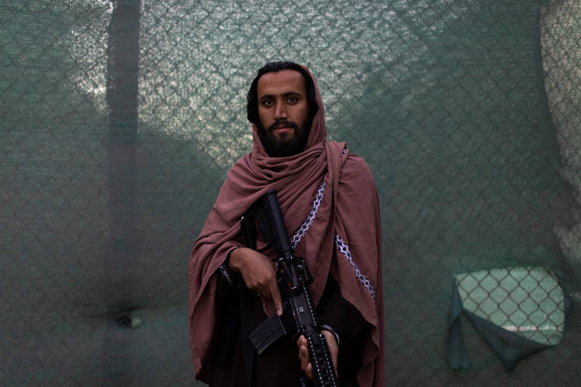 Taliban member Shafiullah, 29, holds a gun outside the border regiment in Kabul on Oct. 23. Shafiullah says he has been fighting with the Taliban for six years. | Reuters