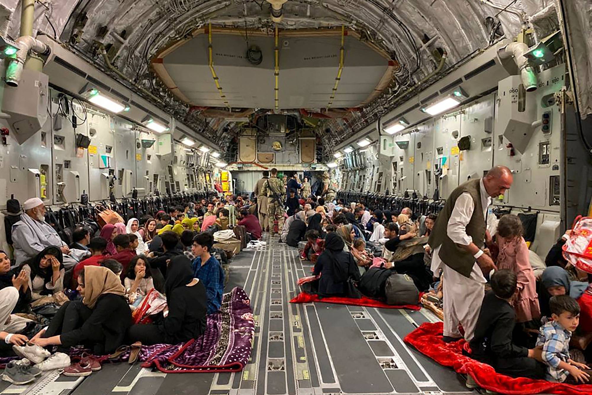 Afghan people sit inside a U.S. military aircraft in Kabul on Aug. 19, after the Taliban's takeover of Afghanistan. | AFP-JIJI