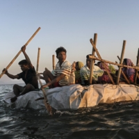 Rohingya refugees cross the Naf River, which divides Bangladesh and Myanmar, in 2017.  | ADAM DEAN / THE NEW YORK TIMES