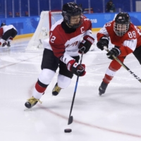 Japan\'s Chiho Osawa skates with the puck during a game against Switzerland during the 2018 Pyeongchang Winter Olympics in Gangneung, South Korea, on Feb. 20, 2018. | REUTERS