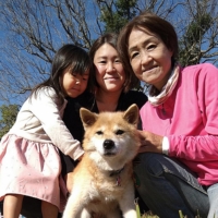 Kyoko Tamura (right), her daughter, Hana Nishimura, and her granddaughter, Kokona, gather around Keane the dog. | COURTESY OF KYOKO TAMURA
