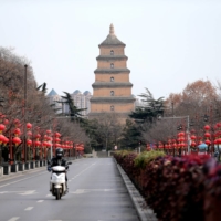 A rider travels on an empty road following lockdown measures to curb the spread of COVID-19 in Xian, Shaanxi province, China on Dec. 26. | REUTERS
