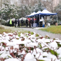 People line up in the snow for nucleic acid testing at a residential compound under lockdown following the COVID-19 outbreak in the Yanta district of Xian, Shaanxi province, China on Dec. 25.  | REUTERS 