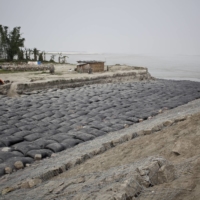 A river embankment construction site at the bank of the Brahmaputra River in Salmora, India in 2013. The river, a critical laboratory in climate studies, has been eroding the island of Majuli in Assam for decades. | .ENRICO FABIAN / THE NEW YORK TIMES