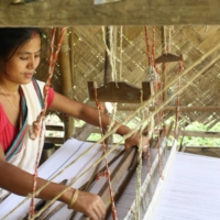 Weaver Rekha Doley works at home in Panbari Mising village in Assam, India.  | IMPULSE SOCIAL ENTERPRISES / VIA THOMSON REUTERS FOUNDATION