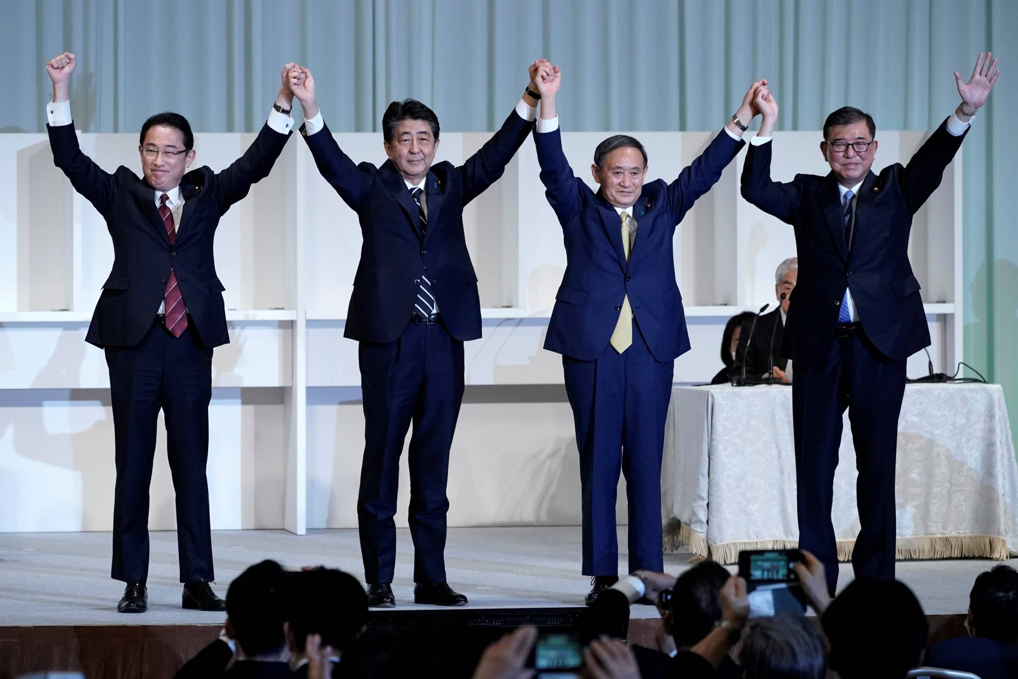 Prime Minister Shinzo Abe, Chief Cabinet Secretary Yoshihide Suga, former Defense Minister Shigeru Ishiba and former Foreign Minister Fumio Kishida celebrate after Suga was elected as new head of the ruling party at the Liberal Democratic Party's leadership election in Tokyo on Sept. 14, 2020. | POOL / VIA REUTERS