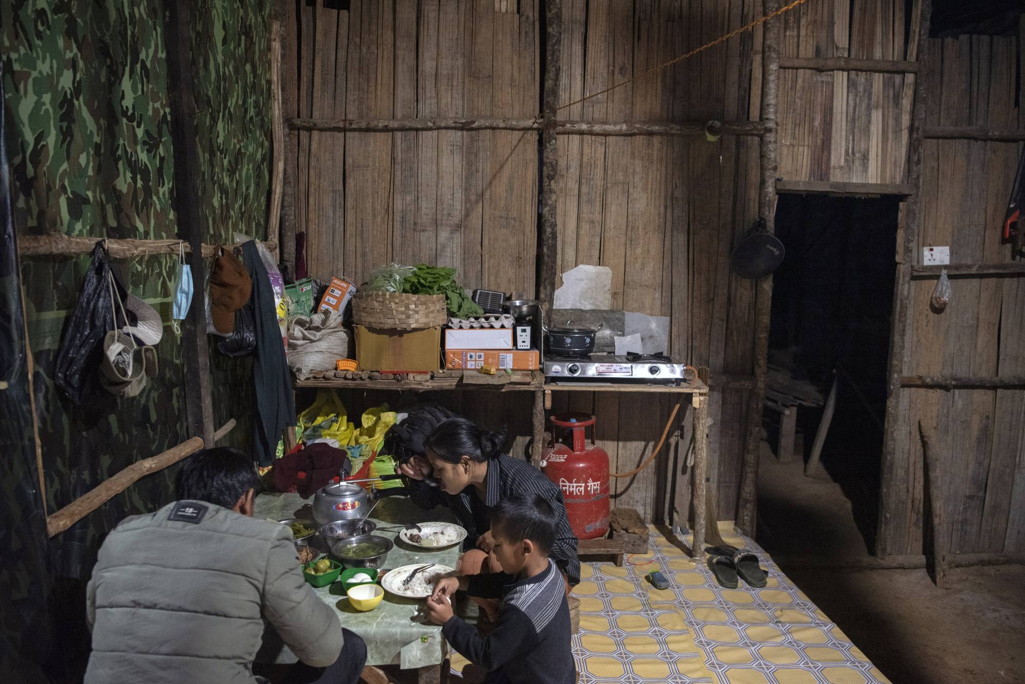 Biak Tling and Tial Hoi Chin dine with their eldest son, Van Nawl Tling, 5, at their new home in Farkawn, India, on Dec. 10. | Saumya Khandelwal / The New York Times