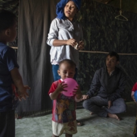 Biak Tling and Tial Hoi Chin in Farkawn, India, on Dec. 10, with their 5-year-old son, Van Nawl Tling, and 18-month-old twins, Bawi Thwang Cung and Bawi Lian Cung. | SAUMYA KHANDELWAL / THE NEW YORK TIMES