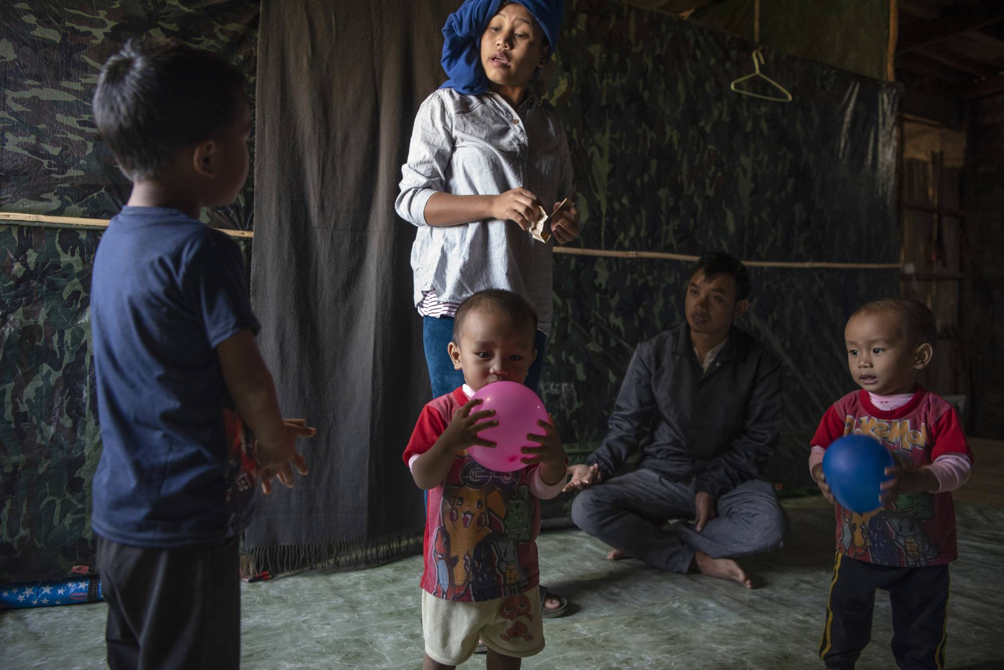 Biak Tling and Tial Hoi Chin in Farkawn, India, on Dec. 10, with their 5-year-old son, Van Nawl Tling, and 18-month-old twins, Bawi Thwang Cung and Bawi Lian Cung. | Saumya Khandelwal / The New York Times
