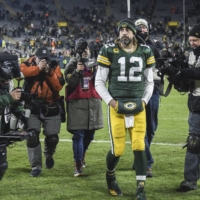 Green Bay Packers quarterback Aaron Rodgers (12) walks off the field after the Packers defeated the Cleveland Browns at Lambeau Field on Sunday. Rodgers has come under fire for not receiving a COVID-19 vaccine. | BENNY SIEU / USA TODAY / VIA REUTERS