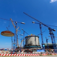A dome is installed over a nuclear power unit at Fangchenggang nuclear power plant in China’s Guangxi Zhuang autonomous region in May 2018. China is expected to pour as much as $440 billion into building new nuclear plants over the next decade or so.   | CHINA DAILY / VIA REUTERS