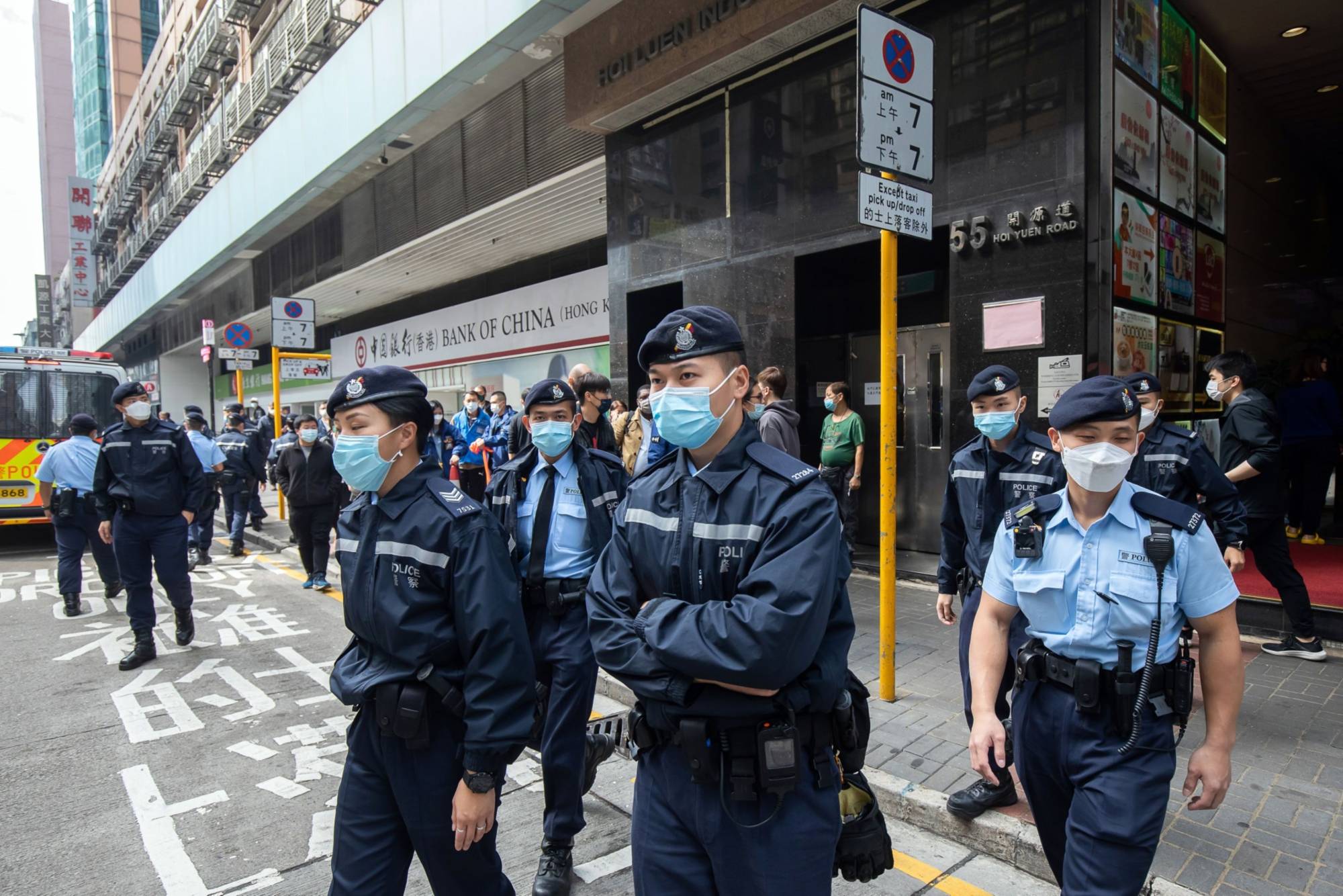 Police officers outside a building that houses the offices of online media outlet Stand News during a raid in Hong Kong on Wednesday. | Bloomberg 