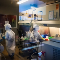 Technicians work in a COVID-19 research laboratory at the African Health Research Institute in Durban, South Africa, on Dec. 15. | BLOOMBERG 