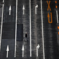 A man walks across an empty road in Tokyo on Dec. 8. | REUTERS