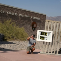 A person poses for a photo next to a thermometer in Death Valley, California, on July 11. | REUTERS 