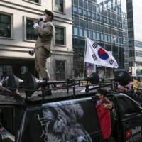 Bae In-kyu, head of Man on Solidarity, one of South Korea\'s most active anti-feminist groups, leads a rally in Seoul on Dec. 12.  | WOOHAE CHO / THE NEW YORK TIMES
